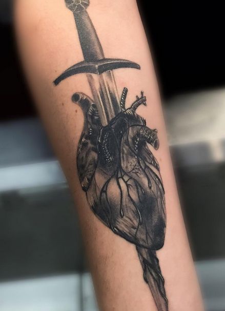 Heart and Knife tattoo by artist Em Becker #tattoo #tattooart #tattooartist #inkart #art #bodyart #tattoos #tattooinspiration #tattooideas #heart #hearttattoo Heart On My Sleeve Tattoo Men, Dager And Heart Tattoo, Knife Going Through Heart Tattoo, Crushed Heart Tattoo, Heart Break Tattoos Men, Knife In Heart Tattoo, Dagger In Heart Tattoo, Heart With Knife Tattoo, Knife Through Heart Tattoo