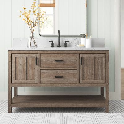 This freestanding single vanity adds a farmhouse feel to your main or guest bathroom. It has a solid and engineered wood base and white quartz backsplash and countertop, with one ceramic under-mount sink. This vanity's rectangular shape and exposed bottom shelf create a casual feel, while the all-over natural wood grain colour variation lends it a rustic look. Store bathroom essentials in its two cabinets and one functional drawer, with soft-close door hinges and drawer, glides. This vanity meas Modern Farmhouse Bathroom Vanity Wood, Quartz Backsplash, Modern Rustic Farmhouse, Quartz Vanity Tops, Wood Vanity, Bathroom Vanity Set, Single Bathroom, Bathroom Essentials, Vanity Top