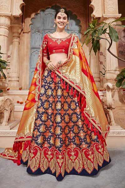 This Ruby red & blue Indian lehenga choli is made of pure jacquard silk. This designer lehenga is embroidered with intricate stonework. It comes with a beautiful silk colour-coordinated dupatta adorned with red tassels and ruby red choli embellished with fine embroidery. Sabyasachi Lehenga, Indian Lehenga Choli, Designer Bridal Lehenga, Indian Bridal Lehenga, Lehenga Online, Choli Designs, Lehenga Choli Online, Ghagra Choli, Party Wear Lehenga