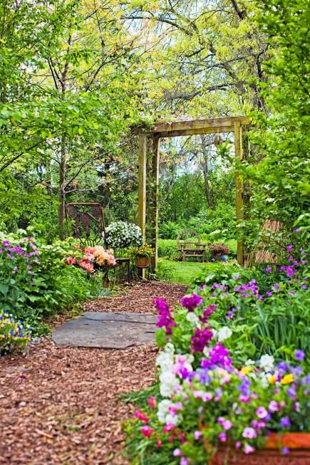 Inviting entrance  An arbor supporting summer-blooming clematis and honeysuckle leads to a prairie garden in this Illinois backyard. Twig chairs and a sculpture made from old garden and farm implements add whimsy. Horse House, Small Flower Gardens, Backyard Flowers Garden, Farm Implements, Prairie Garden, Backyard Flowers, Modern Garden Design, Garden Plans, Woodland Garden