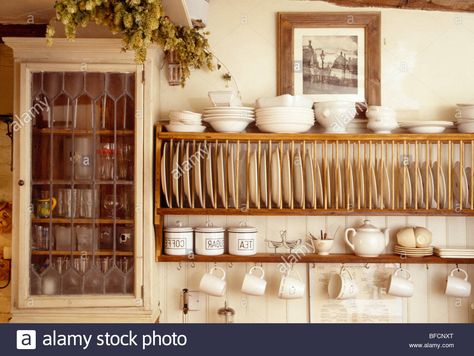 Download this stock image: Close-up of cream bowls on wooden plate rack beside small wall cupboard in cottage kitchen - BFCNXT from Alamy's library of millions of high resolution stock photos, illustrations and vectors. Wall Mount Plate Rack, Plate Racks In Kitchen, Wooden Plate Rack, Plate Rack Wall, Diy Plate Rack, Plate Shelves, Wall Cupboards, Wall Cupboard, Plate Storage