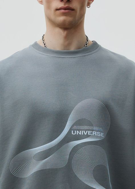 Unisex oversized sweatshirt, made with high-quality cotton, ensuring a soft and comfortable feels. Featuring a stylish print in the UNIVERSE edition. Material: 100% cotton three thread Model wears: L sizeModels height: 188 cm Universe Logo, Minimal Shirt Design, Comfort Clothing, Grey Man, T-shirt Print Design, Cool Shirt Designs, Athleisure Men, Mens Shorts Outfits, French Terry Shorts