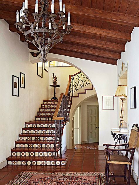 Patterned ceramic tile on the stair risers hint at this home's sophisticated old-world style. The ornate metal railing adds another layer of pattern and architectural interest to the staircase. Spanish Colonial Homes, Hacienda Homes, Spanish Decor, Escalier Design, Plans Architecture, Mediterranean Home Decor, Spanish Style Home, Casas Coloniales, Spanish Style Homes