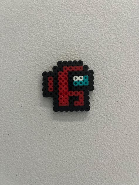 This is a small Among Us design made of Perler beads with a keychain! Customizable colors! Tiny Hama Bead Designs, Perler Bead Patterns Among Us, Dungeons And Dragons Perler Beads, Hama Beads Small Patterns, Cute Melting Bead Ideas, Cool Melty Bead Designs, Iron Bead Art, Cross Perler Beads, Small Perler Ideas