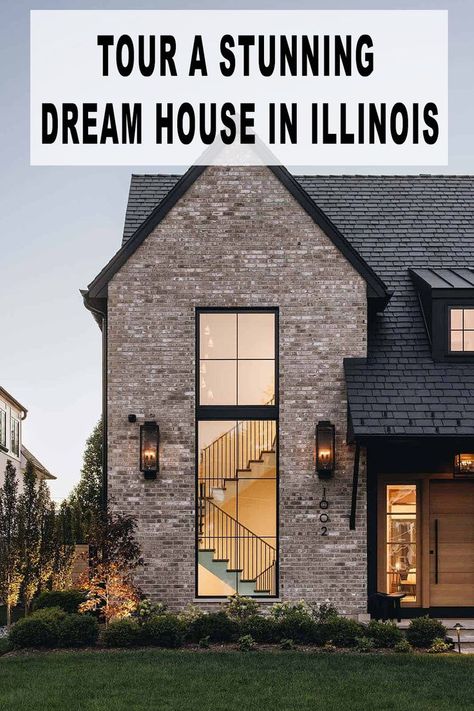 This gorgeous transitional-style dream house was designed by Studio 1 Architects in collaboration with Amy Storm & Company, located in Wheaton, Illinois. On the exterior facade, the black siding, fascia, and roof with the earthy, warm brick are the perfect mix for this home. Montana Ranch House, Black Siding, Wheaton Illinois, Modern Log Cabin, Gambrel Style, Exterior Facade, Outdoor Fireplace Designs, Indoor Swing, Colonial Style Homes