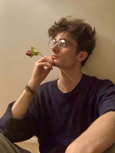 man sat against a white/beige wall in a blue jumper and chequered trousers, holding a rose against their face Charlie Bennett, Barber Style, Haircut Undercut, Undercut Fade, Model Hairstyles, Nerdy Guys, Brown Hair Men, Haircut 2024, Boys Glasses