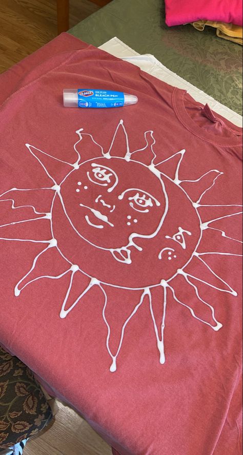 Using a Clorox bleach pen to hand draw a simple design to bleach through on a tshirt. Inspired by trippydraws Sun And Moon Bleach Shirt, What To Draw On A Tshirt, Bleach Art Clothes Aesthetic, Sweatshirt Bleach Design, Bleach Jumper Design, Bleach Painted Sweatshirt, Tshirt Bleaching Ideas, Cool Bleach Designs, Bleach Jacket Design