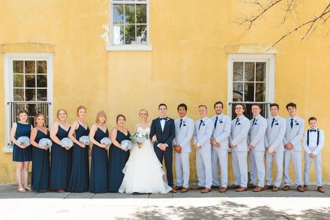 Summer William Aiken House wedding in Charleston, SC.  Couple included their two dogs with adorable navy bow ties. Wedding colors of navy blue and white. Grandmother flower girls. Buried a bottle of whiskey to fend off rain. And bubble send off.  Click on the link to view more from this July William Aiken House Wedding! Steel Blue Bridesmaid Dresses Navy Suits, Wedding Thrifting, Blue Crew Wedding, Blue Bridesmaid Black Groomsmen, Seersucker Groomsmen, Navy Bridesmaids And Groomsmen Grey Suits, Seersucker Wedding, Bubble Send Off, Bottle Of Whiskey