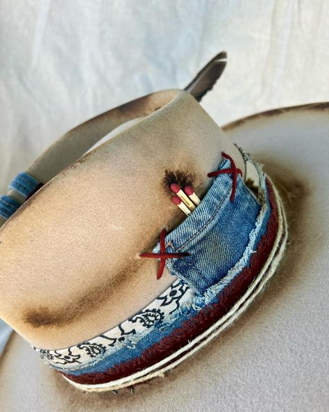 “Wrangler” Custom burned silver belly flat brim western hat with hand sewn details, matches, denim work, leather, bullet casing, twine and feathers. Quality wool felt hat with flat brim. One of a kind. Size: Small (6 7/8 - 7) $250 https://theroguecowpoke.etsy.com/listing/1793759836 How To Burn Hats, Beaded Hat Brim, Burned Felt Hat, Band Inspiration, Burned Hats, Boho Hats, Custom Cowboy Hats, Hat Inspiration, Band Ideas