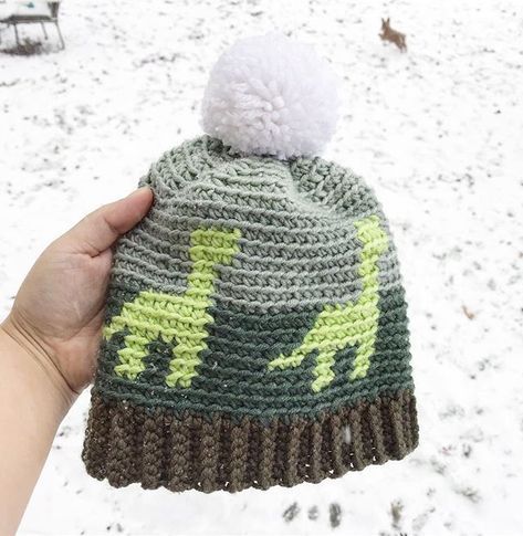 Crochet this dinosaur beanie for kids with just one skein of Caron x Pantone yarn. #dinosaur #kids #crochet Crochet Dinosaur Hat Free Pattern, Crochet Boy Hat, Crochet Dinosaur Hat Pattern Free, Crochet Childrens Hats Free Patterns Boys, Toddler Boys Crochet Hats Free Pattern, Boys Hat Crochet, Crochet Dinosaur Beanie, Toddler Crochet Hat Pattern Free, Free Dinosaur Hat Crochet Pattern