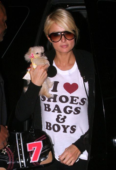 Paris Hilton’s 20 Most Iconic 2000s Looks, From Juicy Couture to Rhinestones  | W Magazine Y2k Slogan, 2000s Looks, Iconic 2000s, 2000s Barbie, 2000s Party, Slogan Tees, Trashy Y2k, Heart Shoes, Retro Tops