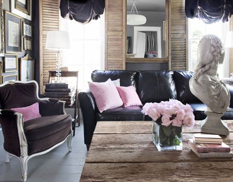 Living Room with Contrast
Old Rule: White walls are a must when square footage is limited.

New Rule: Dark colors create the illusion of depth in small rooms. 

Every wall is painted the same charcoal hue. In the living room, pink pillows and weathered woods offer contrasting colors and textures. Black Leather Furniture, Black Couch Living Room, Black Leather Couch, Feminine Living Room, Black Couches, Black Leather Sofas, Eclectic Living Room, Small Space Living Room, Leather Couch