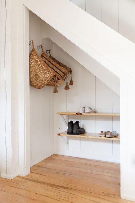 Storage space is essential in small home, and the woven bags provide more room to store hats and mittens in the winter. Under Stairs Nook, Room Under Stairs, Space Under Stairs, Stair Nook, Closet Under Stairs, Stairs Renovation, Diy Staircase, Staircase Storage, Under Stairs Cupboard