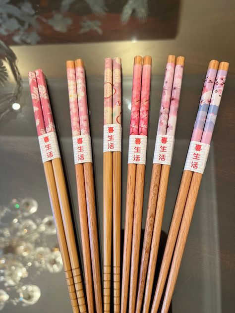 This listing  is for 1 (one) pair of japanese chopsticks.  there are 12 design variations to this listing.  they are very very beautiful.  they have different designs on them with pink being the main color.from left to right---1)pink with greyish on dark stained wood, 2)pink with flowers with hint of lavender on dark stained wood, 3)pink with white flower on dark stained wood, 4)pink with pink flowers on dark stained wood,5)pink with pink flowers on light wood, 6)pink with white flowers on light wood, 7)pink with white flower with some red on light wood, 8)  pink with leaves on light wood, 9) pink with purple and red roses, 10)pink with roses and fans on ligght wood, and 11)pink with pretty flowers with yellow and green colors on light wood  12) pink with hint of lavender on light wood.. i Japanese Chopsticks Aesthetic, Cool Chopsticks, Chopstick Aesthetic, Pretty Chopsticks, Aesthetic Chopsticks, Kawaii Chopsticks, Chopsticks Aesthetic, Pink Chopsticks, Beautiful Chopsticks