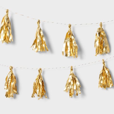 Transform any celebration into a dazzling affair with the Metallic Gold Tassel Garland from Spritz™. This elegant garland features shimmering metallic gold tassels to add glamor to your party decor. With its easy setup and practical design, the metallic gold tassel garland from Spritz™ is an ideal choice for birthdays, weddings, graduations and more. Golden Party Ideas, Golden Birthday Ideas For Him, Fearless Birthday Party, College Grad Party Decorations, Golden Birthday Decor, Gold 21st Birthday Decorations, Golden Year Birthday Ideas, Gold Classroom Decor, Gold And Silver Party