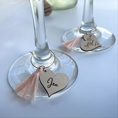 "Personalized wine glass charms add a special touch to the table, and help guests feel valued and appreciated. Perfect for small intimate affairs, or large celebratory gatherings. When given as a party favor guests will cherish the memories of your special event each time they use their personalized wine charms. Details: 1\" diameter Personalize one or both sides Tassels are available in Red or Peach Shapes available: Circle Heart *When ordering multiple wine charms please list the name as you w Wine Glass Favors, Wedding Wine Charms, Hen Party Decorations, Wine Glass Tags, Bridal Shower Tags, Hen Party Bags, Bridal Shower Wine, Wedding Wine, Personalized Wine Glass