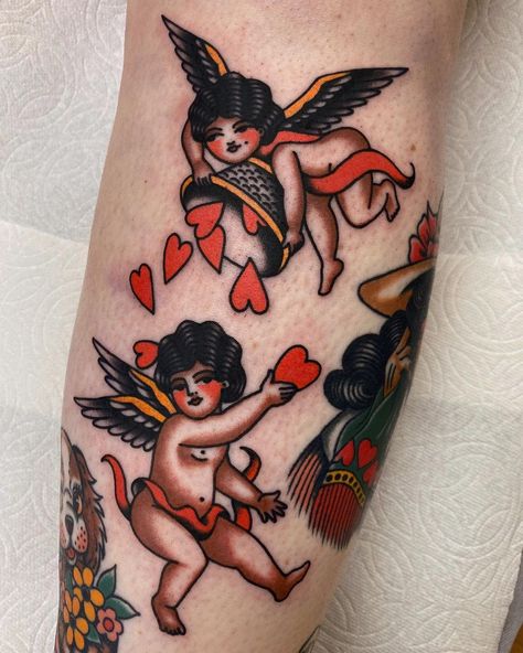 @blair_maxine_mckenna on Instagram: “Some bebs down the front of the shin between a couple perfect @katherinepruetattoo tats. Thanks heaps @abbi.matthews ❤️…” Tattoo Of Angel, Traditional Tattoo Love, Chest Tattoo Designs Female, Traditional Tattoo Woman, Shin Tattoo, Cherub Tattoo, Traditional Tattoo Designs, Card Tattoo Designs, Coffee Tattoos