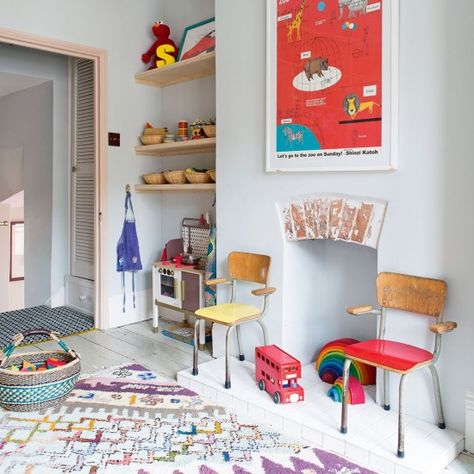 Keep the backdrop to a children's room understated and clean-ups and updates are easy. This blue-grey shade is soothing and gender neutral and can be accessorised with an assortment of happy brights. A fun zoo animal print mounted on the chimney breast takes the lead and rainbow coloured toys act as decoration as well as play things. A fun patterned rug makes the hard-wood floor soft for little feet while two colourful reclaimed school-style chairs are retro cool. Playroom Alcove Ideas, Playroom Idea, Retro Nursery, Victorian Villa, Alcove Shelving, Bright Accessories, Casa Hobbit, Ideas Habitaciones, Patterned Rug