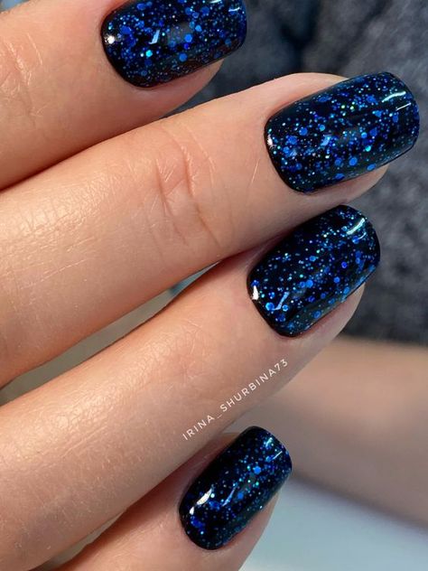 19 Gorgeous Winter Acrylic Nail Colors for 2023-2024 - thepinkgoose.com Gel Nails For January, Glitter Gel Acrylic Nails, Black Nails Blue Glitter, Blue Dip Nails With Glitter, Black And Blue Short Nails, Black And Blue Glitter Nails, Blue Dipped Nails Ideas, Gel Polish Manicure Short Nails, Sparkly Nails Blue