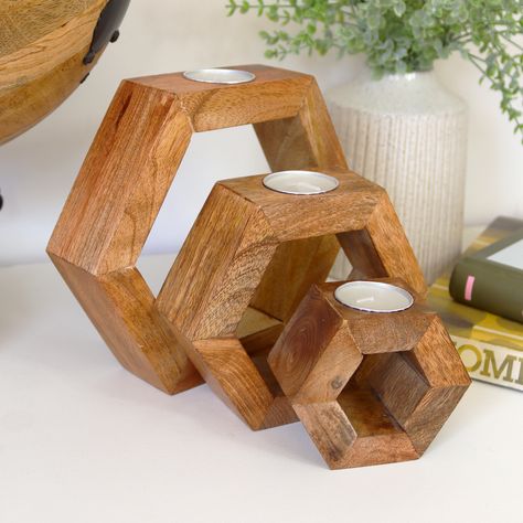 This Set of 3 Hexagonal Tea Light Holders brings warmth and charm to any space. Crafted from natural mango wood, these wooden block hexagons nest together beautifully, creating a versatile display. The set includes three tea light holders, each with a unique and natural finish, along with three tealights. Perfect for adding a cosy ambiance to your home, these holders combine rustic appeal with functional design. Wooden Block Hexagons Set Of 3 Nesting Natural Mango Wooden Finish Tea Light Holder 3x Tealights Included Large Dimensions W20cm x H18cm x D5cm Medium Dimensions W15cm x H13cm x D5cm Small Dimensions W10cm x H10.5cm x D5cm Colour Light Brown Wood Material Mango Wood Wood Block Candle Holder, Wood Tea Light Holder, Wooden Tea Light Holder, Block Candles, Shop Projects, Tea Light Holders, Wood Shop Projects, Wooden Candle Holders, Wood Candle Holders