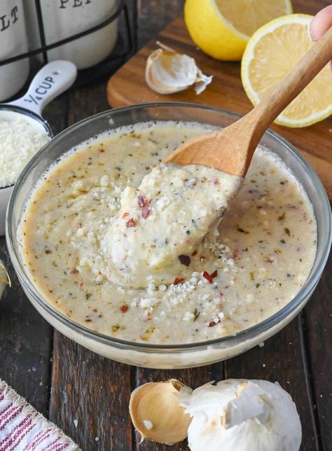 Using a wooden spoon to stir a bowl of garlic parmesan sauce. Copycat Buffalo Wild Wings, Wild Wings Garlic Parmesan Sauce, Wings Garlic Parmesan, Parmesan Sauce Recipe, Parmesan Wing Sauce, Garlic Wings, Parmesan Wings, Garlic Parmesan Wings, Wing Sauce Recipes