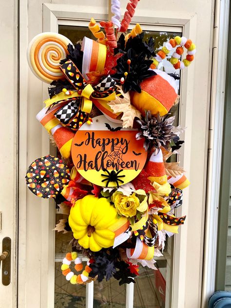 A large Halloween swag with candy corn theme , greenery, flowers, and matching bows . Pine Cone Candy Corn Wreath, Pinecone Candy Corn Wreath, Candy Corn Wreath Mesh, Candy Corn Wood Wreath, Circus Halloween Wreath, Corn Theme, Halloween Whimsical, Halloween Decorations Diy, Wreath Business