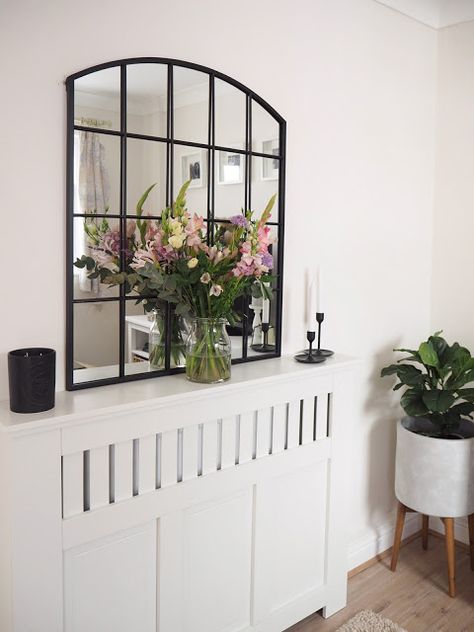 How to style a radiator cover in your living room using accessories and items you already own including artificial greenery, candles and flowers. Contemporary Radiators, Black Radiators, Mini Lanterns, House Redesign, Decor Hacks, Artificial Greenery, Home Decor Hacks, Cosy Corner, Radiator Cover