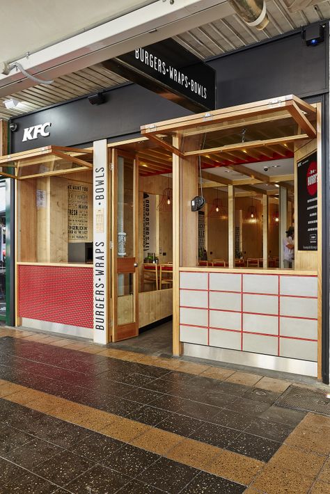 CONTEMPORARY AND INVITING, THE NEW KFC FAST-CASUAL RESTAURANT CONCEPT CATERS TO YOUNG URBANITES. KFC has joined the current trend of fast-casual restaurants and created a new concept store offering a more varied menu of burgers, burritos and salads to capture the young urban crowd. The Great Indoors teamed with branding and design agency, Designworks to deliver a holistic brand experience and spatial design. Warm timber, black industrial metal, concrete and highlights of the KFC red brand col Kfc Restaurant, Food Court Design, Food Illustration Design, Casual Restaurant, Fast Casual Restaurant, Casual Restaurants, Spatial Design, Kiosk Design, Hospital Interior Design