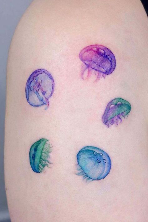 Discover the art of transformation with jellyfish tattoos in our article. Explore it and find 50+ stylish designs with meanings explained. Finding Yourself Tattoos, Cute Jellyfish Tattoo, Jellyfish Tattoo Color, Jelly Fish Tattoos, Color Tatoos, Watercolor Jellyfish Tattoo, Moon Jellyfish Tattoo, Tattoo Ideas Colorful, Watercolor Tattoo Design