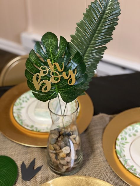 Dino Themed Centerpieces, Dino Table Centerpiece, Wild Baby Shower Theme Boy, Jungle Safari Centerpieces Ideas, Table Centerpieces For Baby Shower Boys, Gold And Green Baby Shower Ideas, Baby Dinosaur Centerpieces Ideas, Jungle Baby Shower Theme Centerpieces, Jungle Baby Shower Table Decor