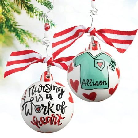 Filled with ruby red hearts, this lovely design features the phrase "nursing is a work of heart" and a customizable scrub top on the back. Personalize with her name and a year to make this distinctive design complete! Includes red and white striped ribbon and beads along the hanging wire. Size: 4" W x 4" H. Medical Ornaments Diy, Medical Ornaments Christmas Trees, Nurse Christmas Ornament, Nurse Ornaments Vinyl, Nurse Ornament, Nurse Ornaments, Xmas 2024, Heart Christmas, Striped Ribbon