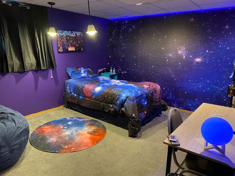 My preteen son outer space bedroom! Wall art, bed spread, rug, led lights and moon lamp all off amazon. Outerspace, universe bedroom, dark purple bedroom, preteen bedroom, boys bedroom, epic bedroom! Galaxy Walls Bedroom, Galaxy Wall Bedroom Ideas, Universe Room Ideas Bedrooms, Outer Space Room Ideas, Galaxy Room Painting Ideas, Universe Room Decor, Galaxy Painted Wall, Purple Galaxy Bedroom, Purple Space Bedroom