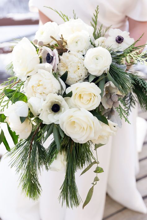 White rose, anemone, ranunculus, peony, brunia, pine, christmas greens bridal bouquet Greens Bridal Bouquet, Winter Wedding Flowers Bouquets, Pinecone Wedding, Anemone Bridal Bouquet, Winter Bridal Bouquets, Christmas Greens, Simple Wedding Bouquets, Bridal Bouquet Peonies, White Ranunculus