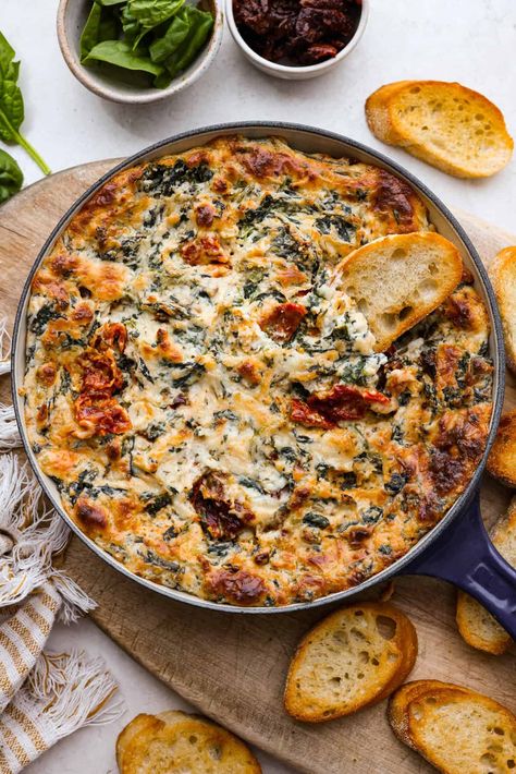 There's a new appetizer in town, and this creamy Tuscan dip won everyone's hearts! The combination of cheeses, garlic, spinach, and sun-dried tomatoes creates an addicting dip you’ll want to bring to all of your gatherings! Appiterzer Dips, Party Apps Finger Foods, Tuscany Appetizers, Sun Dried Tomato Appetizer Recipes, Good Side Dishes To Bring To A Party, Sunday Funday Dip, Mediterranean Appetizers Appetizer Ideas, Focaccia Dip, Mediterranean Dip Recipes