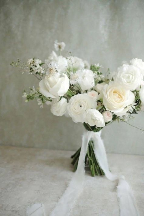 White Winter Wedding Bouquets With Greenery, White Rose And Magnolia Bouquet, Monochromatic Bridal Bouquet, Loose White Bouquet, White Ranunculus Wedding Bouquet, Ranculus Flowers Bouquet, White And Green Ceremony Flowers, Dainty Wedding Bouquet, Whimsical Bridesmaid Bouquet