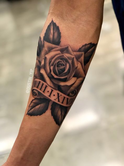 Mens Cross And Rose Tattoo, Rose And Date Tattoo Men, Rose Tattoo Design Black And Grey, Tattoos With Names In Them For Men, Men's Rose Tattoo, Rose Tattoo With Birth Year, Rose Tattoo Arm Man, Masculine Rose Tattoo Men, Manly Rose Tattoo Men