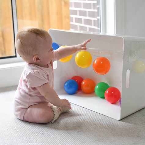 Exploring Sticky! 🖐🏼 Introducing Rory’s new favourite game! A length of sticky tape with balls stuck, for her to pull or smack off! 😋  Rory (6.5 months) is getting so confident with moving & reaching whilst sitting! This little invitation was so easy to set up & kept her busy, swatting balls before I even had a chance to stick them back up!  This would make a great tummy time activity too; allowing your Baby to shift body weight, balance & reach - all skills needed in preparation for crawling Baby Development Activities, Baby Sensory Play, Baby Play Activities, Busy Boxes, Baby Activities, Baby Learning Activities, Baby Education, Preschool Art Activities, Montessori Baby