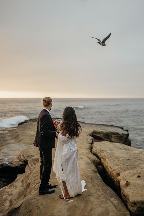 Bride and groom looking out at the ocean during their cliffside elopement in San Diego. See more Southern California elopement locations, Southern California elopement ideas, and Southern California elopement photos! Book Kim for your destination wedding photography or California elopement photography at kimkayephotography.com! Sunset Cliffs San Diego Elopement, Elopement Location Ideas, Sunset Cliffs Elopement, San Diego Photography Locations, Lighthouse Elopement, Cliff Elopement, Elopement Activities, Sunset Cliffs Wedding, Oregon Spring