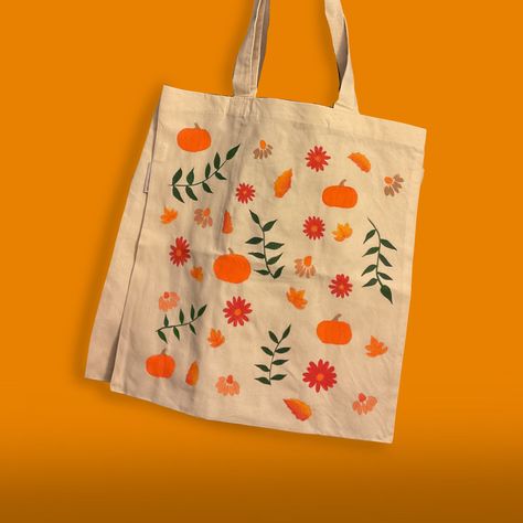 Embrace eco-conscious style with our hand-painted Fall Things Tote Bag! Featuring all the things you love about autumn, this reusable, eco-friendly bag is both a work of art and a sustainable choice for everyday use. Make a statement and reduce your environmental footprint with every outing. Tote Bag Info: *100% Organic Cotton *Standard Size (15"W x 16"H) with 21" Handles *Reinforced at stress points for extra durability!  *Design made using a mix of acrylic and fabric mediums *Care instructions will be included to ensure a long lasting product! *Colors may vary slightly from picture CARE INSTRUCTIONS: Cleaning of 100% cotton bags by washing machine is not recommended as washing shrinkage may occur. Hand wash is recommended. Hang dry is necessary before high- temperature ironing. **DO NOT Halloween Tote Bags Diy Paint, Fall Tote Bag Painting Ideas, Canvas Bag Painting, Canvas Tote Bag Design, Painting Tote Bags, Autumn Tote Bag, Painted Tote Bag, Spooky Basket, Handpainted Tote Bags