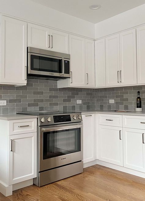 white kitchen with soffits and dark gray and blue backsplash tile Galaxy White Granite Countertops, White Galaxy Granite Countertops, White Subway Tile Kitchen Backsplash Dark Cabinets Granite Countertops, Galaxy Granite Countertops, White Galaxy Granite, White Marble Tile Backsplash, Color Tile Backsplash, White Granite Slabs, Galaxy Granite