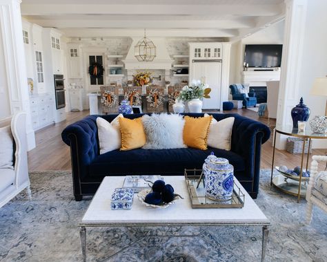 Home with Holly J | This fall, I've added pops of mustard and blue in my living room decor to make it eye-catching and extra cozy. #falldecor #autumndecor #mustard #throwpillows #navycouch #coffeetable #livingroom #livingroomdecor #livingroomstyling #frenchcountrydecor #hometour Blue Sofas Living Room, Blue Couches, Highland Homes, Blue Sofa, Mantle Decor, Living Room Coffee Table, Blue Decor, Fall Home Decor, Autumn Home