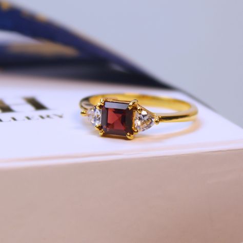 Crimson Glow Ring Celebrate love and the festive spirit with this enchanting 14k Gold Natural Red Garnet Ring. Featuring a vibrant square-shaped garnet and sparkling cubic zirconia accents, it’s perfect as an engagement ring, a thoughtful Christmas gift, or a timeless keepsake. A blend of elegance and sentiment, crafted to captivate hearts. ☑️ Lifetime Warranty. ☑️ Islandwide Delivery. ☑️ Authorized dealer from National Gem & Jewellery Authority. Contact us for more details: 076 014 6956 |... Glow Ring, Red Garnet Ring, Thoughtful Christmas Gifts, Garnet Ring, Celebrate Love, Garnet Rings, Gems Jewelry, Red Garnet, Natural Red