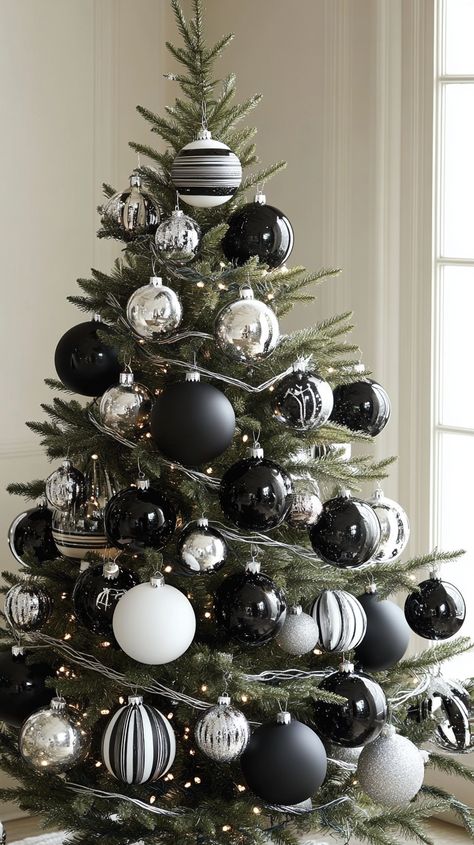 Black and white striped ornaments and glass baubles on a Christmas tree create an elegant winter wonderland theme. White Silver Black Christmas Tree, Christmas Tree Decorations Black White, Black And Silver Christmas Decor, Striped Ornaments, Striped Christmas Tree, Black And White Christmas Decor, Black And White Christmas Tree, Marble Ornaments, White Christmas Decor Ideas