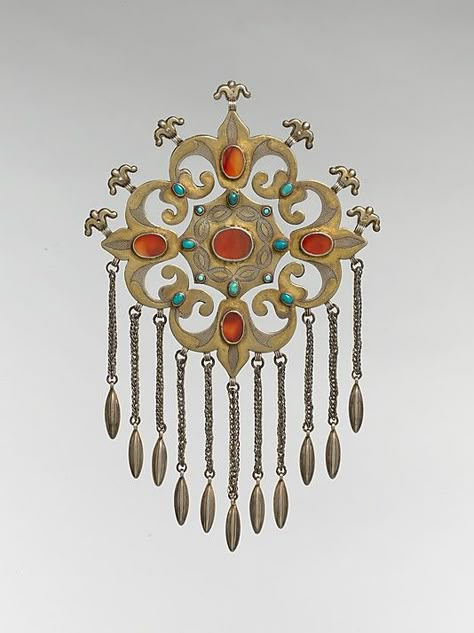 Object Name: Pectoral ornament  Date: late 19th–early 20th century  Geography: Central Asia or Iran  Culture: Islamic  Medium: Silver, fire-gilded and chased, with ram's-head upper terminals, openwork, wire chains, embossed pendants, table-cut carnelians, and turquoise beads Afghan Jewelry, Floral Type, Silver Ornaments, Turkish Jewelry, Ancient Jewelry, Central Asia, Traditional Jewelry, Ethnic Jewelry, Antique Jewellery