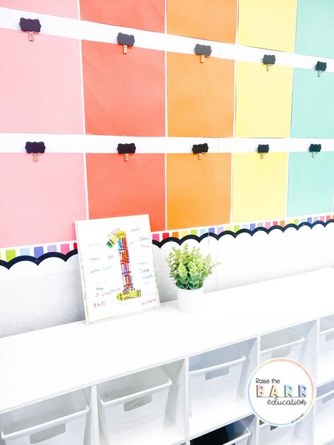 Student work display wall with colorful scrapbook paper and wood clips Wow Wall Classroom Display Student Work, Display Student Work Bulletin Board, Student Work Wall, Student Work Bulletin Board, Student Work Display, Display Student Work, Preschool Classroom Layout, Rainbow Display, Classroom Prep