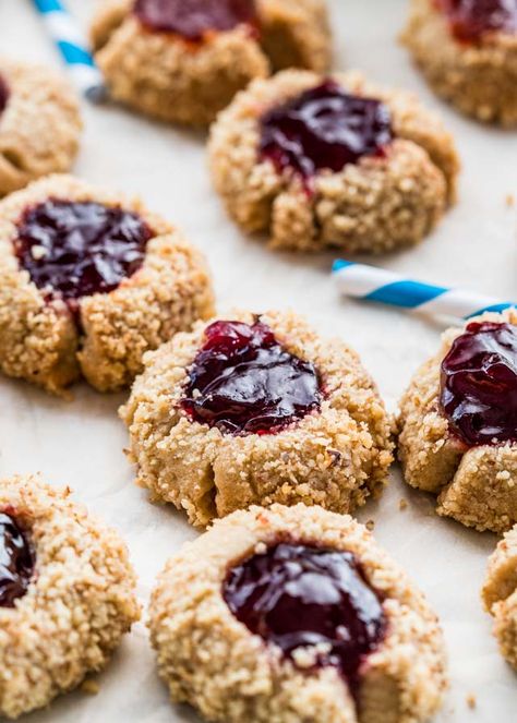 These Thumbprint Cookies are the perfect holiday cookies. Cookie dough balls are coated in walnuts then topped with raspberry jam. An old fashioned cookie but a classic and incredibly delicious! www.jocooks.com #thumbprintcookies Thumbprint Cookies Christmas, Best Thumbprint Cookies, Thumbprint Cookies Easy, Cookies With Jam, Raspberry Thumbprint Cookies, Jam Thumbprint Cookies, Christmas Jam, Christmas Food Treats, Jo Cooks