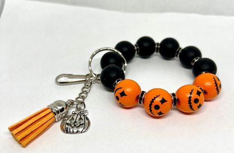 Unbelievable offer! Halloween Beaded Keychain Wristlet - Bright and Colorful Accessory - Jack-o-lantern, at an incredible price of $15.99 Don't miss out on this sensational deal! #LeatherTassel #OrangeBlackBeads #HandmadeKeychains #UniqueKeychains #WristletKeychains #KeychainGift #HalloweenAccessory #KeyringBracelet #HandmadeKeyring #15MmSiliconeBeads Handmade Keychains, Halloween Beads, Keychain Wristlet, Unique Keychains, Beaded Keychain, Colorful Accessories, Wristlet Keychain, Halloween Accessories, Beaded Keychains