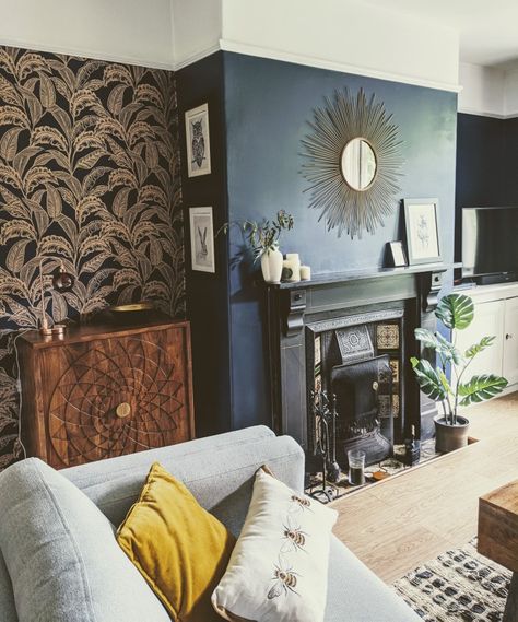 Dark blue room. Living room ideas. Sun mirror. Victorian fireplace. Gold and blue wallpaper. Bee cushion. John Lewis drinks cabinet. Yellow. Wallpapered rooms. Dark Blue Wallpaper Living Room, Wallpaper Chimney Breast Living Room, Wallpaper Fireplace Wall Living Room, Living Room Blue Wallpaper, Wallpaper Chimney Breast, Dark Blue Feature Wall Living Room, Victorian Living Room Wallpaper, Chimney Breast Wallpaper, Gold And Blue Wallpaper