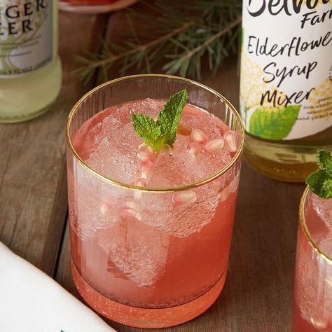 Blood Orange and Elderflower Christmas Cocktail-Drinks-Recipes-Inspiration | World Market Christmas Cocktail Drinks, Fruity Cocktail, Blood Orange Juice, Christmas Cocktail, Mint Sprig, Fruity Cocktails, Cocktail Drinks Recipes, Drinks Recipes, Christmas Cocktails