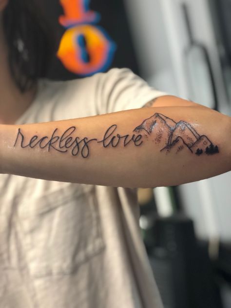 Reckless Love of God female forearm tattoo with mountains Reckless Love Of God Tattoo, Reckless Love Tattoo, Fear God Tattoo, Female Forearm Tattoo Ideas, Tattoo Ideas Female Forearm, No Fear Tattoo, Tattoos Jesus, Reckless Love Of God, Tattoo Word Fonts